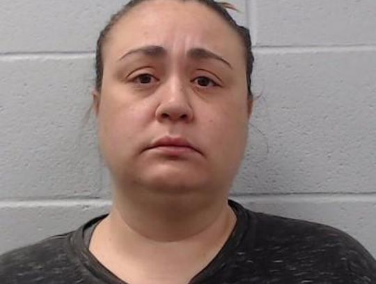 Buda woman arrested after pointing gun at child