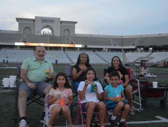DINO-MITE TIME: Crowd gathers to watch Jurassic World at Bobcat Stadium