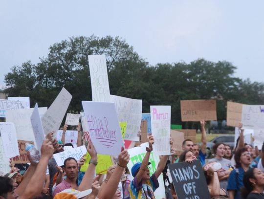 During protest against film production studio, city councilmember announces economic deal to be reconsidered 