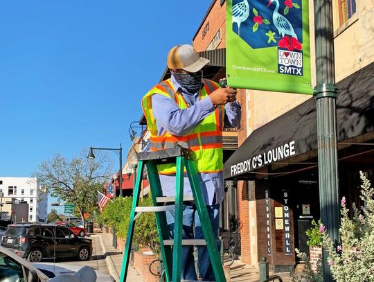 GETTING INTO THE SPIRIT: Downtown street banners receive holiday cheer