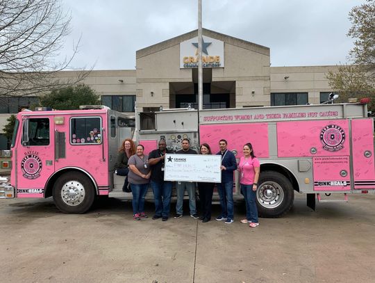 Grande presents Pink Heals Hays County with check