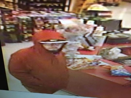 Gunman in red hoodie  robs convenience store 