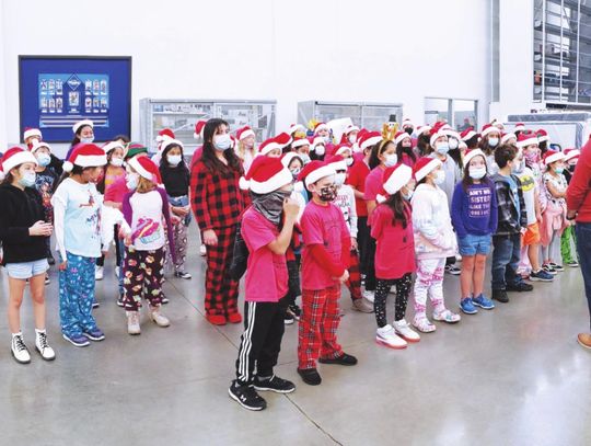 Mendez Striker Choir sings Christmas carols at local businesses