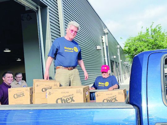 Rotarians pack 910 bags of food for School Fuel