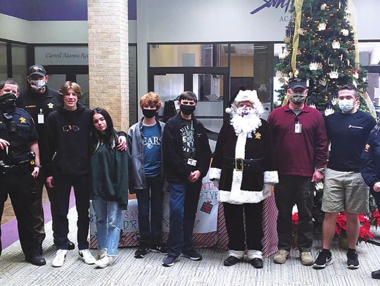 San Marcos Academy's Corps of Cadets presents toys for Brown Santa