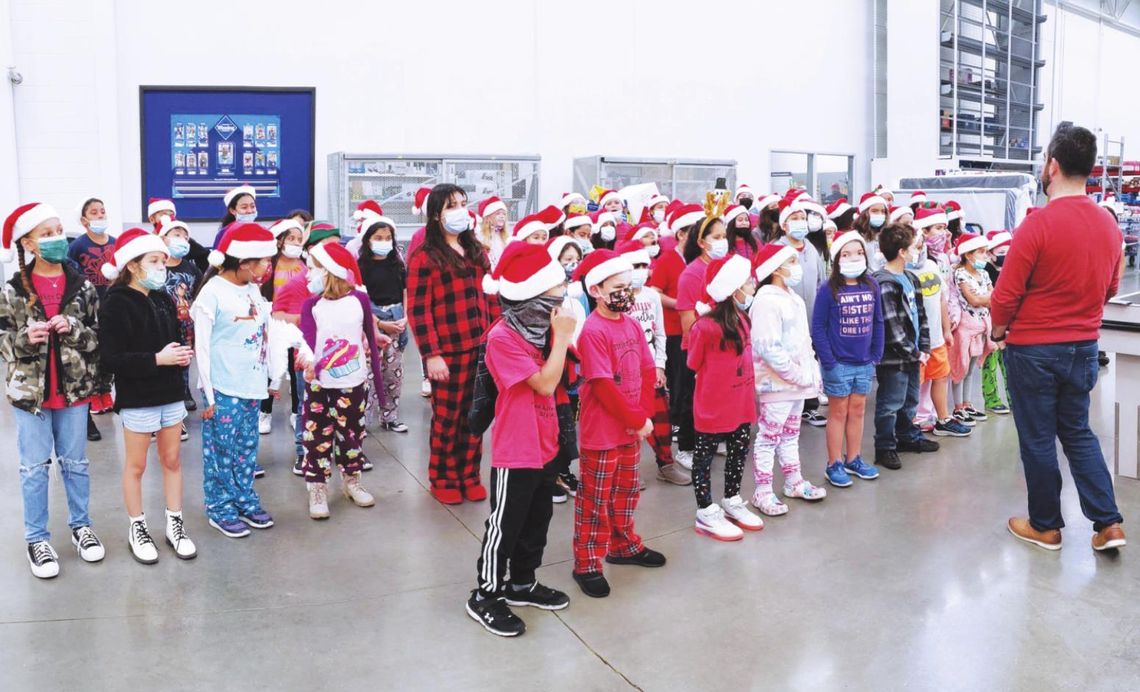 Mendez Striker Choir sings Christmas carols at local businesses