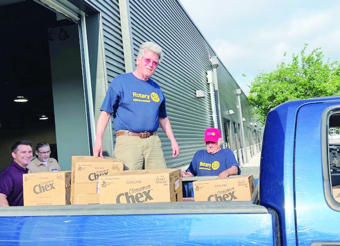 Rotarians pack 910 bags of food for School Fuel Rotarians pack 910 bags of food for School Fuel