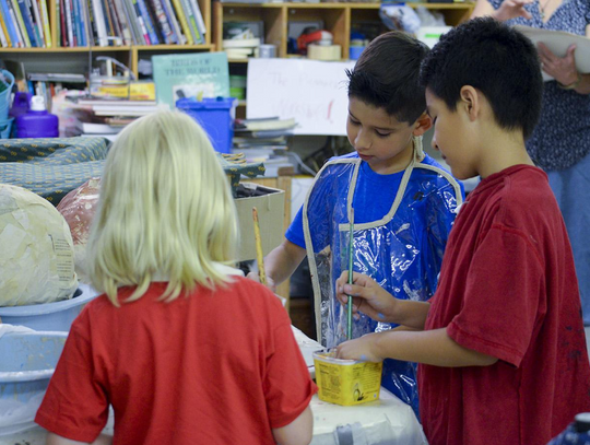 Evangeline Straubhaar, Mateo Flores and Gerardo Saucedo begin mixing colors to create the perfect shade of red to use on a life-size ethnic mermaid puppet to be on display during the Mermaid Promenade