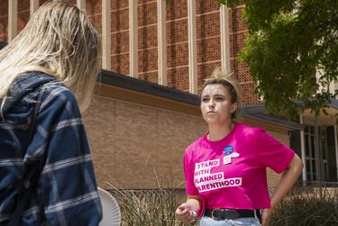 Sofia Bell talks with a potential voter about voting against Proposition A on the Texas Tech University campus on May 1, 2021, in Lubbock.