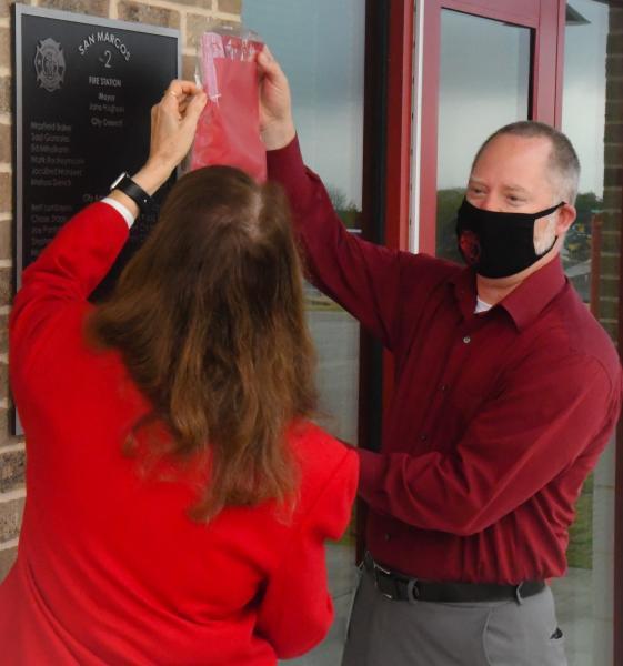 Above, Mayor Jane Hughson and Director of Public Safety Chase Stapp unveil the dedication plaque at the new San Marcos Fire Station #2 during a grand opening ceremony on Wednesday. Daily Record photo by Lance Winter